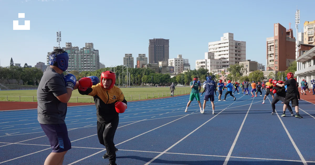 Boxers practice on a running track with others. photo – Free Man Image ...