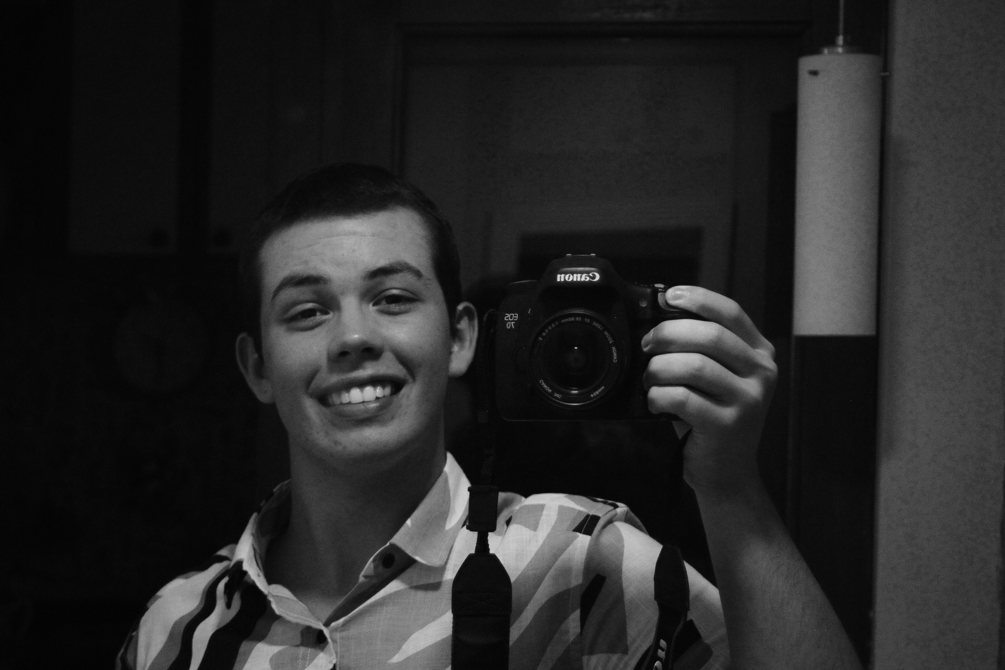 Man smiles while taking a selfie with a camera. photo – Free Portrait ...