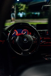 BMW car interior, illuminated at night.