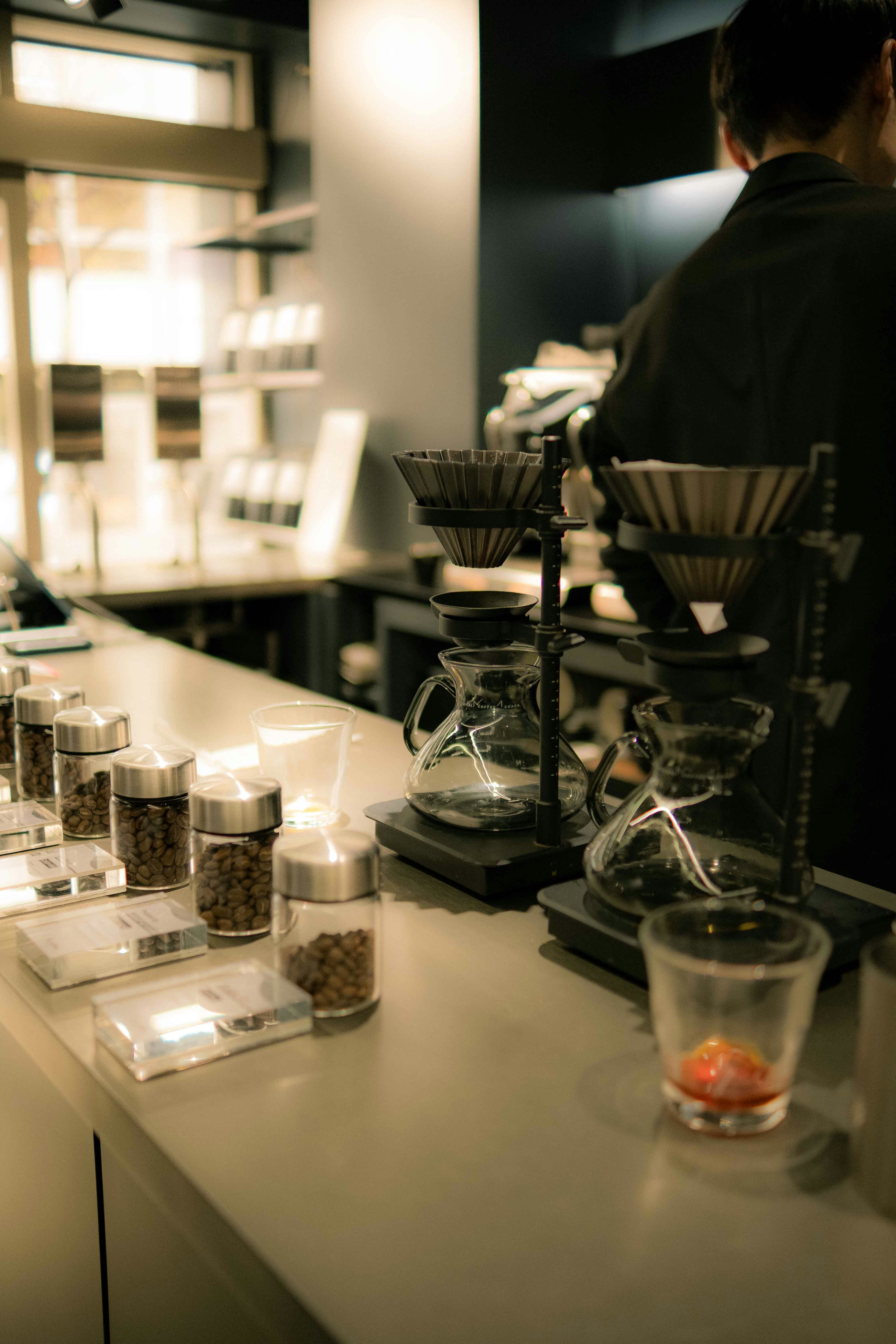 Coffee shop setup with brewing equipment and beans.