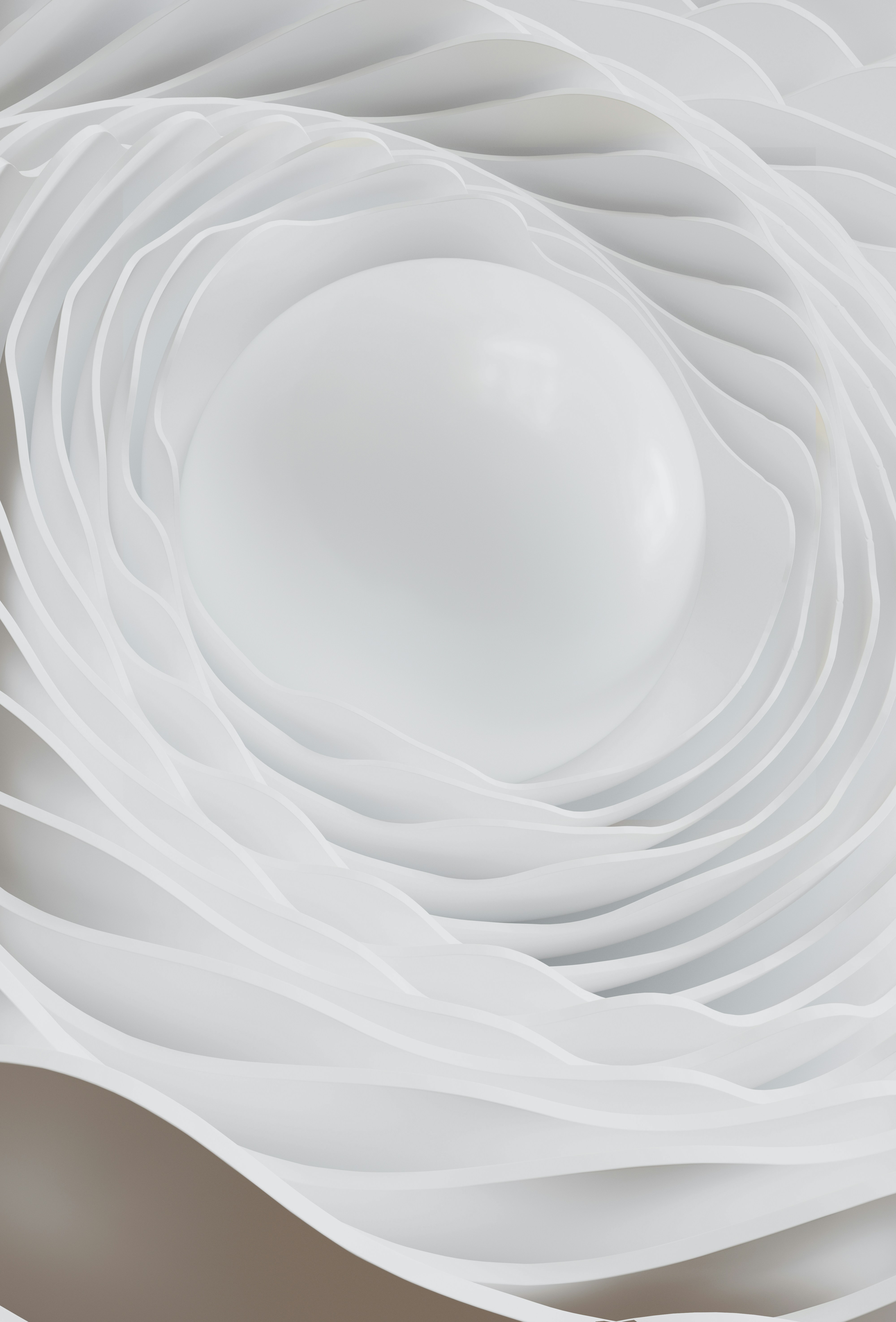 Sphère blanche entourée de couches texturées ondulées.