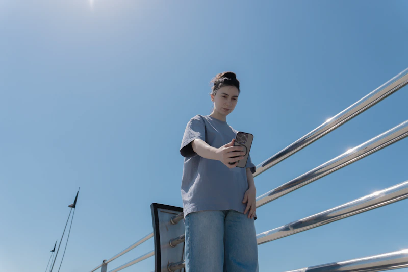 Woman taking selfie in sunlight