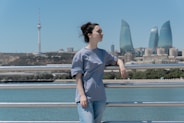 A woman poses with a city skyline.