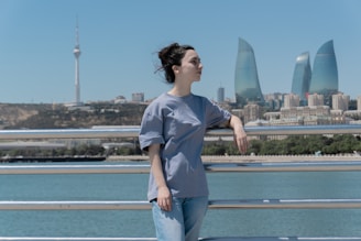 A woman poses with a city skyline.
