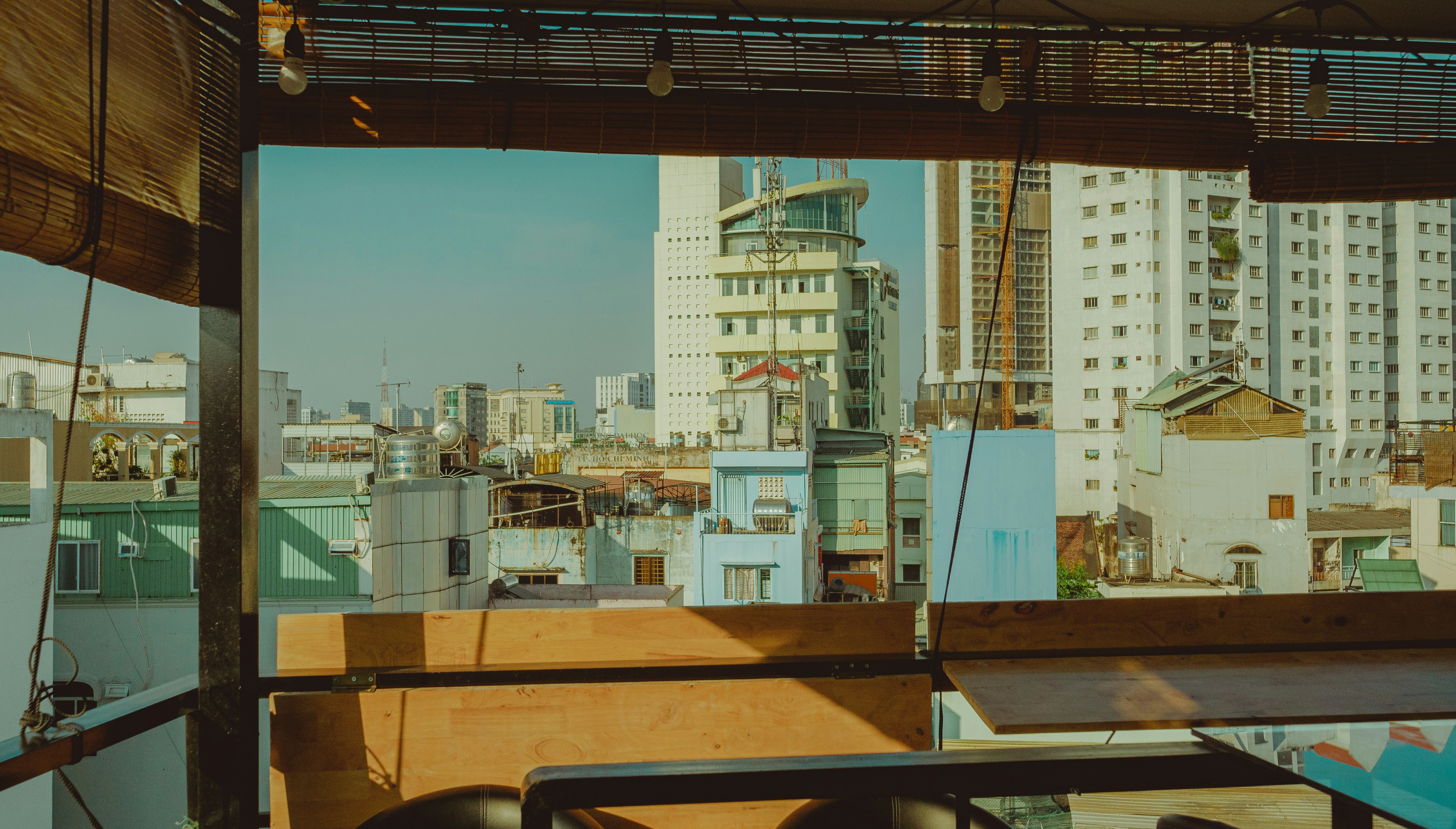 Resident smiling while using a treadmill with a city view in the background - apartments with fitness center