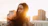 Woman looks serene with the setting sun.