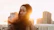 Woman looks serene with the setting sun.