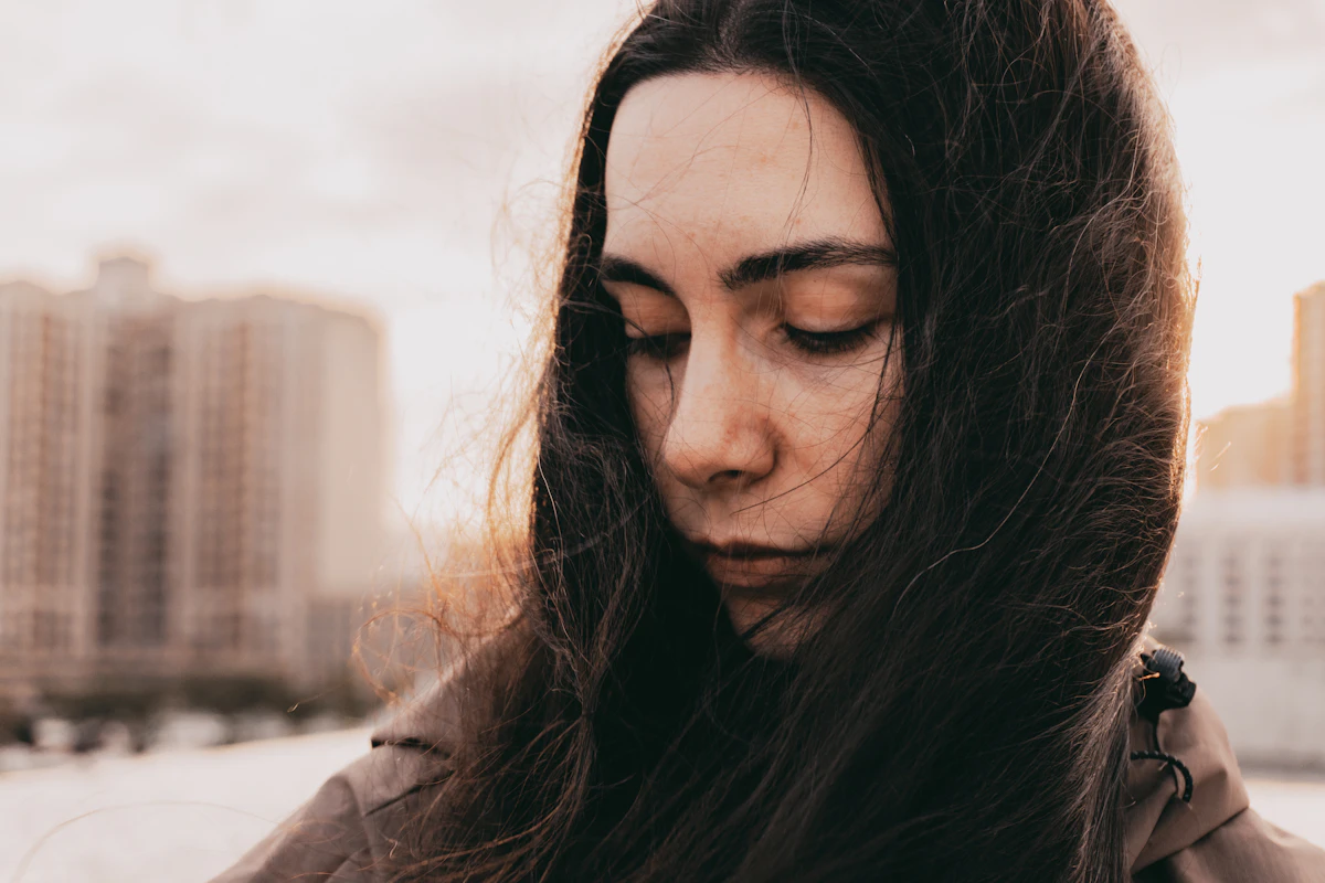 Woman looking down thoughtfully