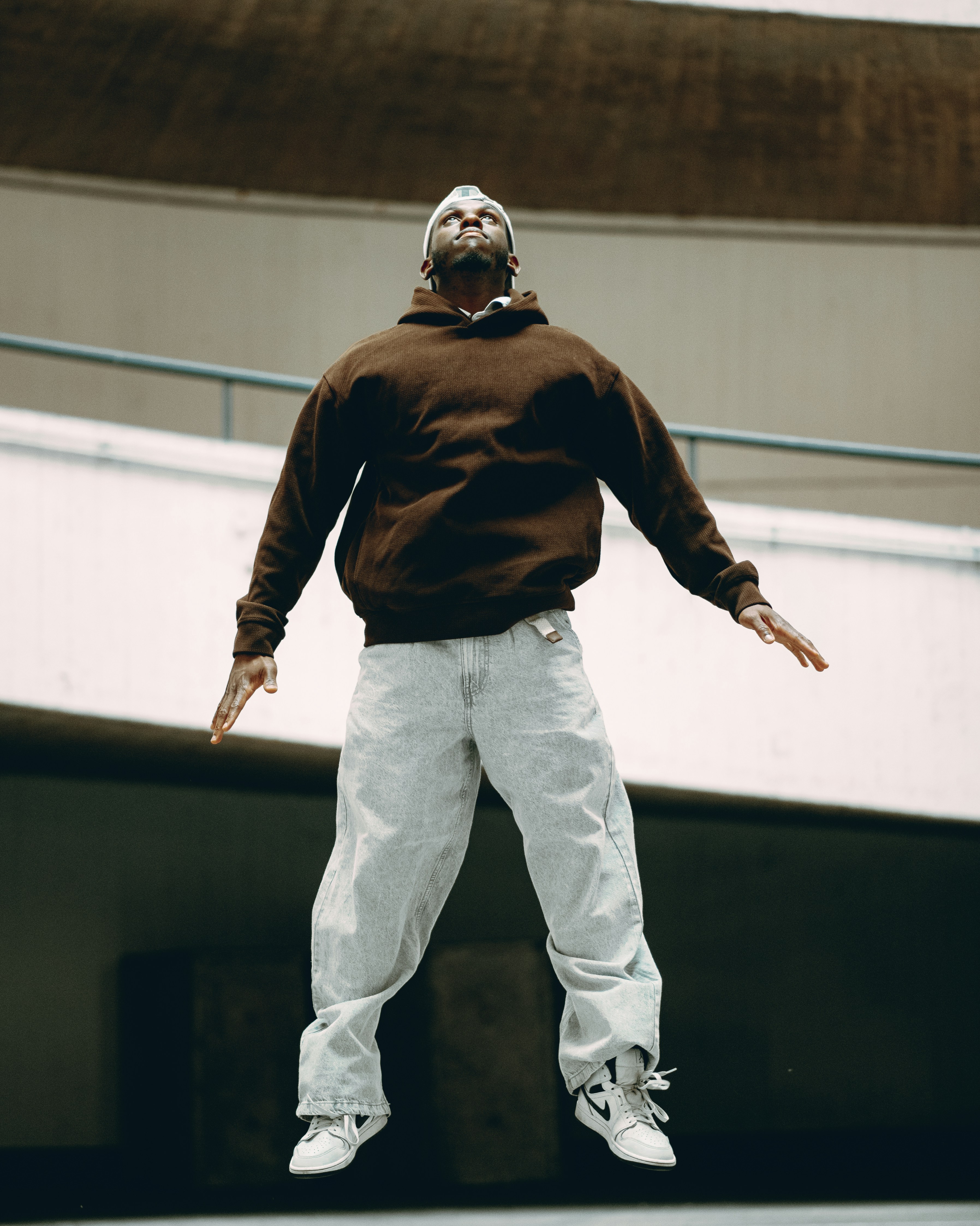 Man leaps in the air with arms outstretched.