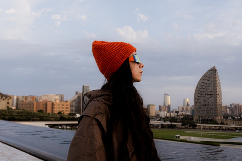 Confident woman posing against city skyline
