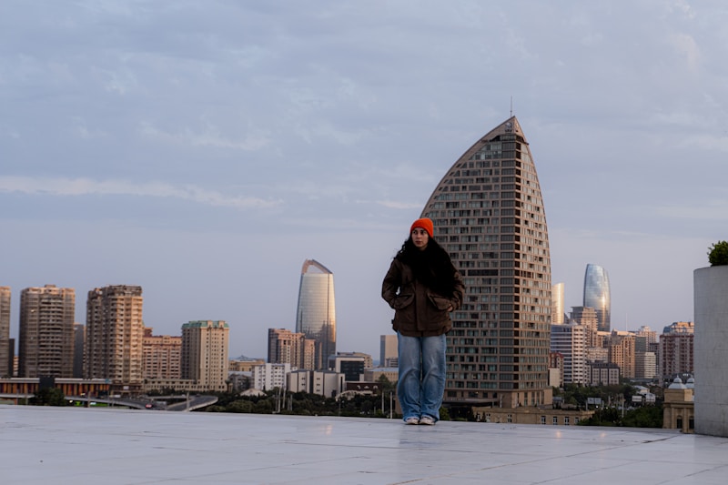 Empowered woman on rooftop with urban skyline
