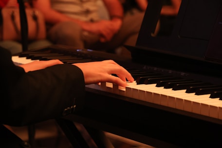 Hands play the piano in concert.