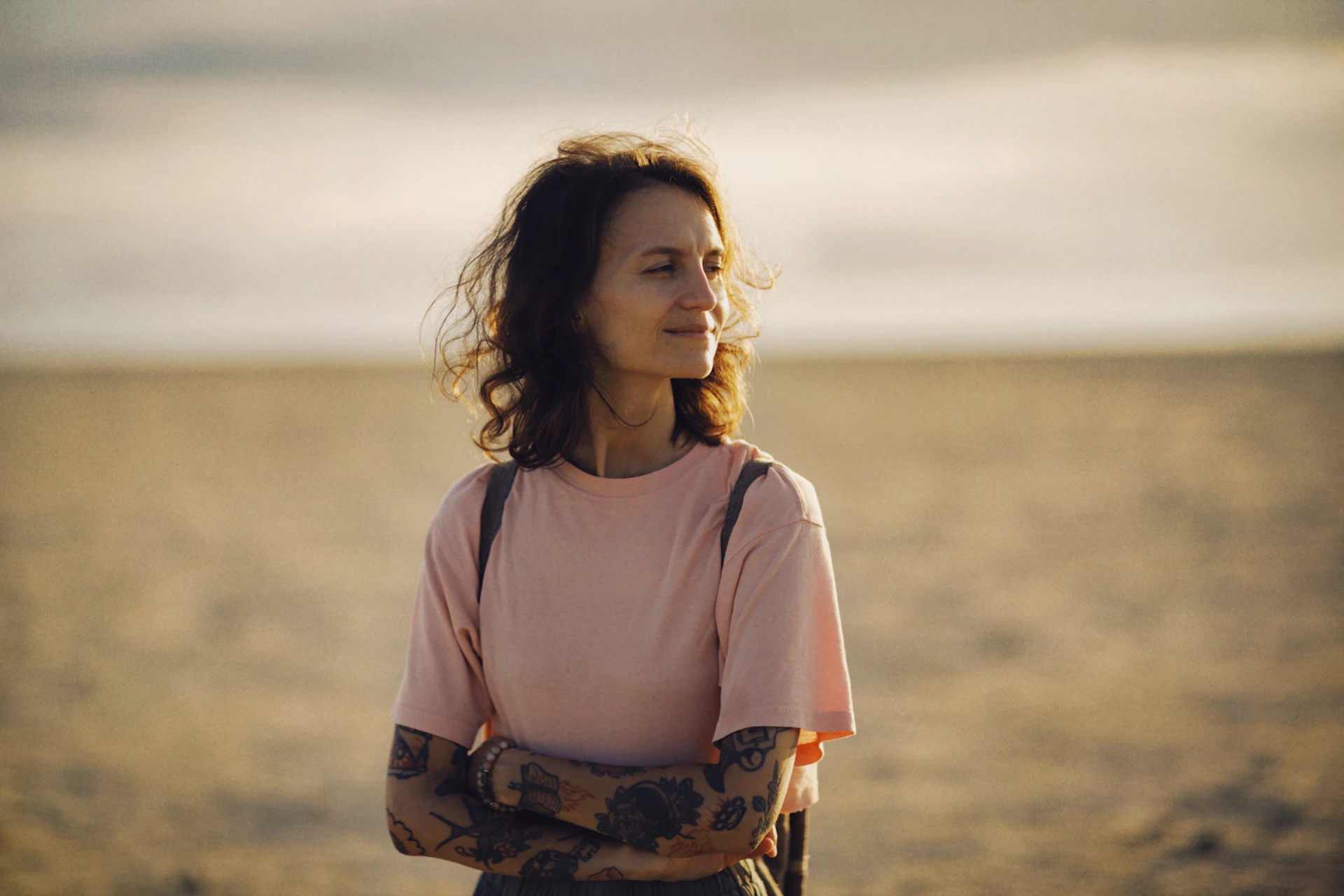 A woman looks off into the distance.
