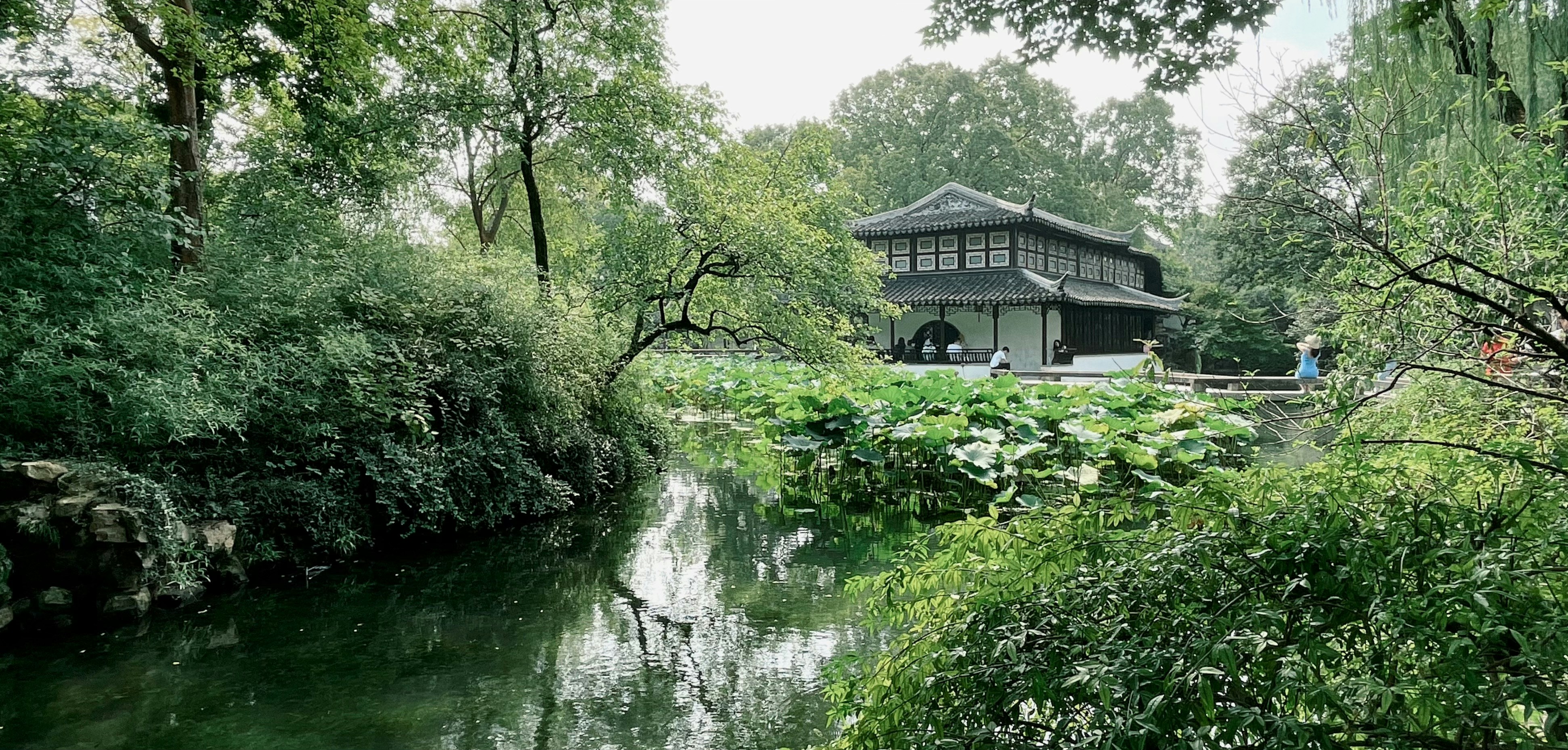 A serene landscape with a building near water.