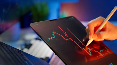 Someone is analyzing a stock market graph.