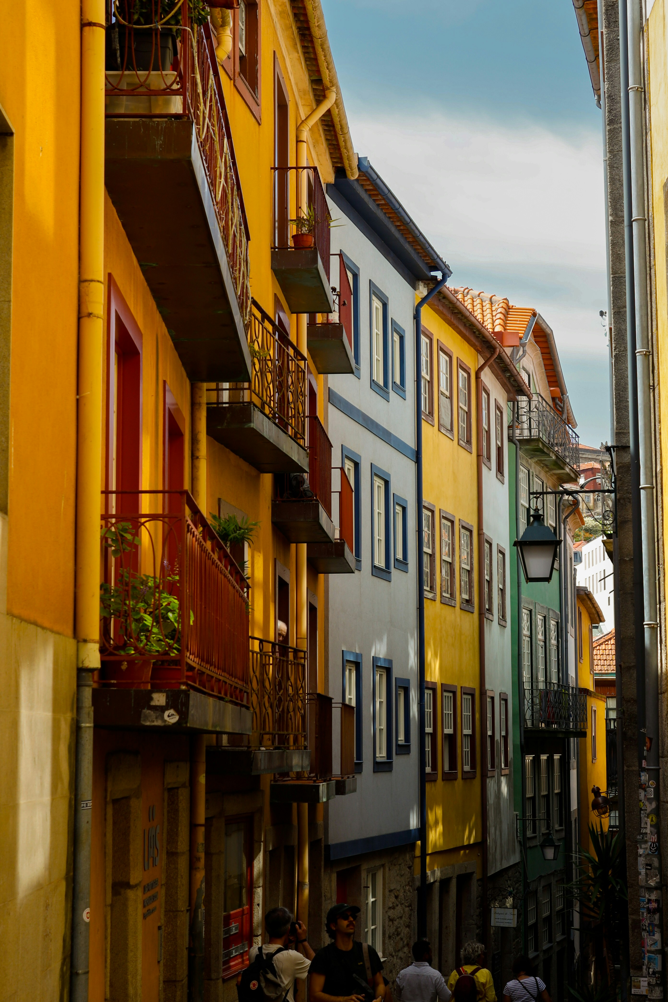 Colorful buildings line a narrow street.