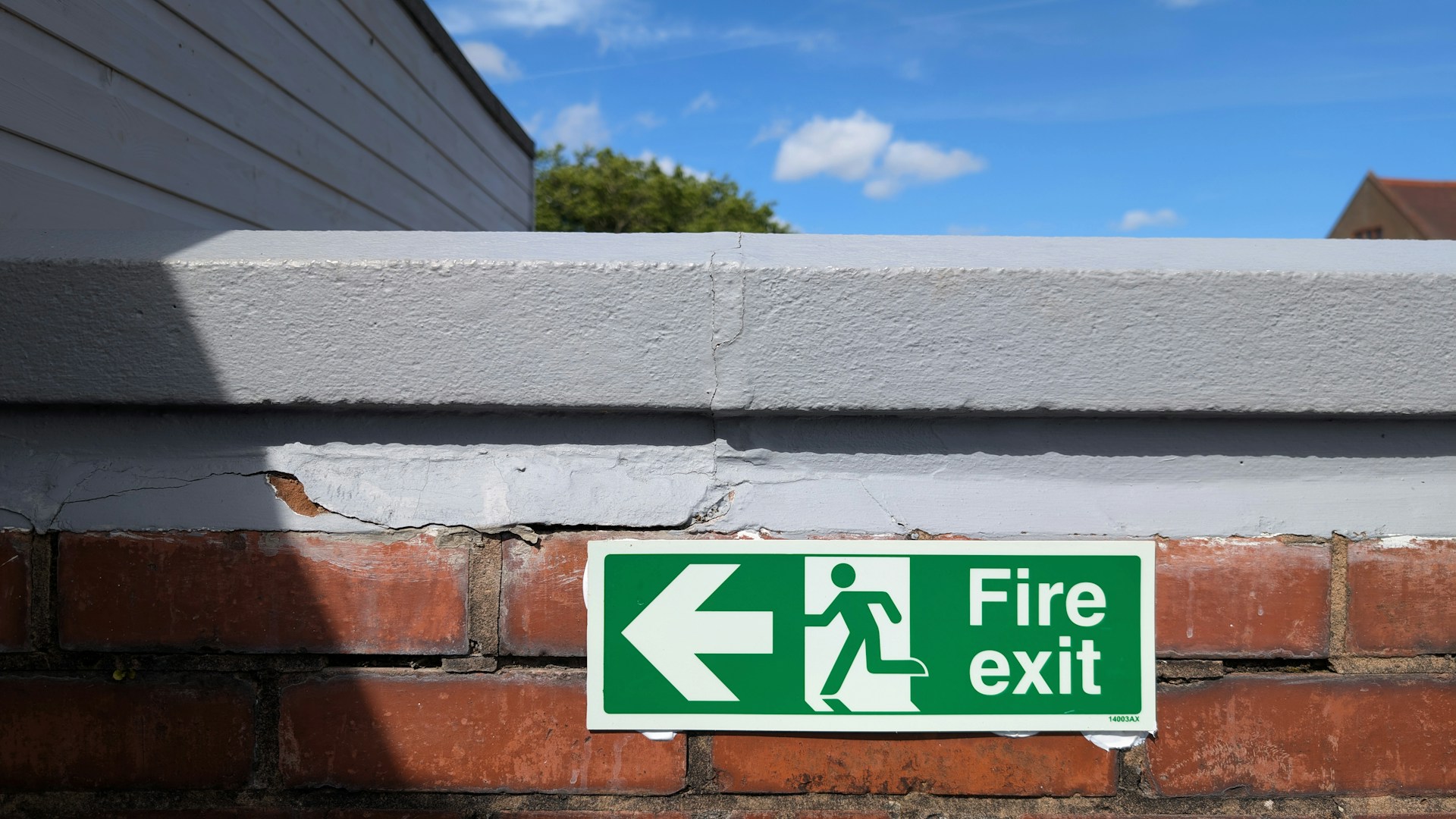Fire exit sign points towards the left.