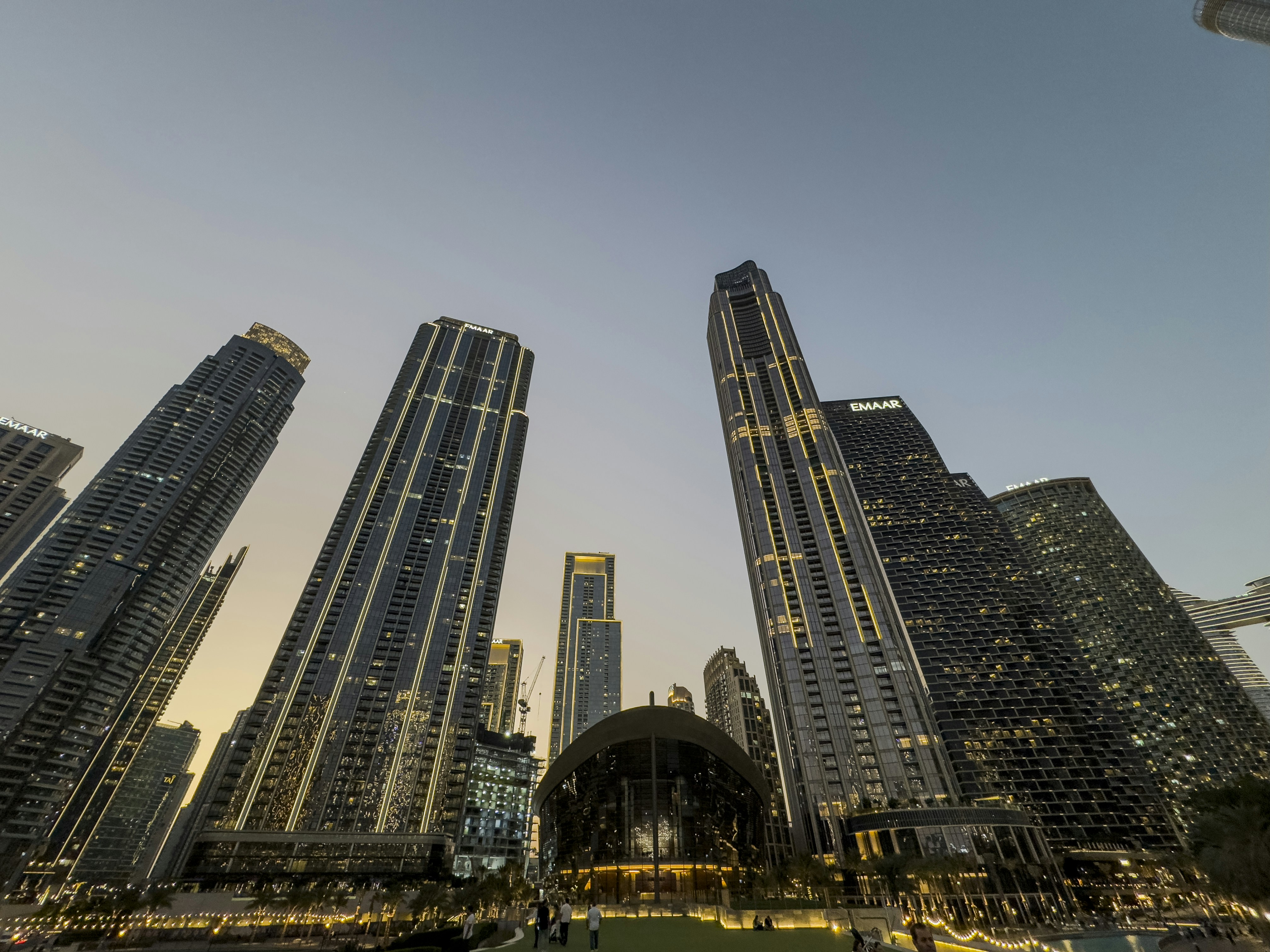 Skyscrapers tower in a city during dusk.