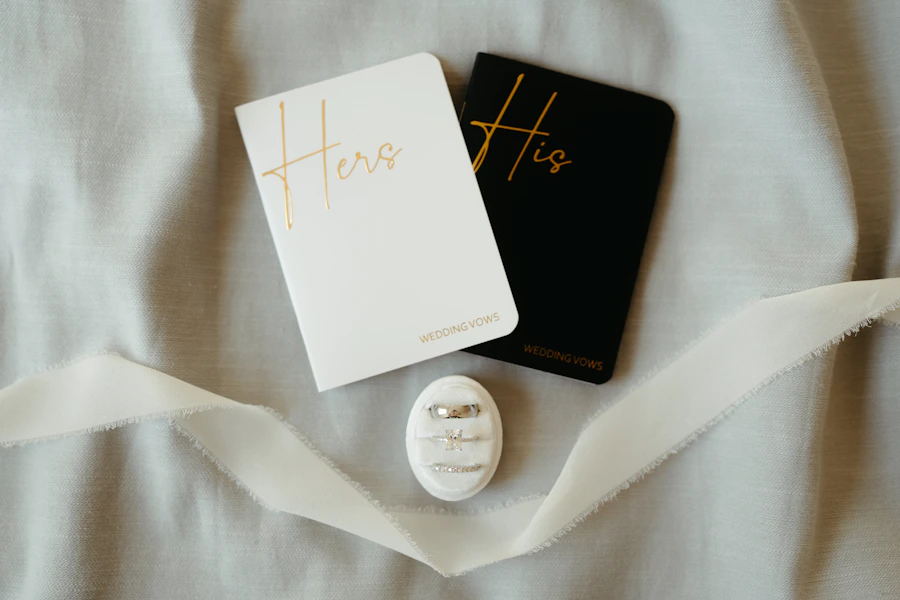 His and hers wedding vow books with wedding rings