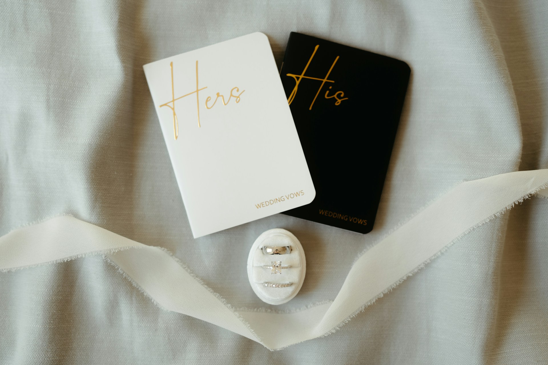"his and hers notebooks and wedding rings."