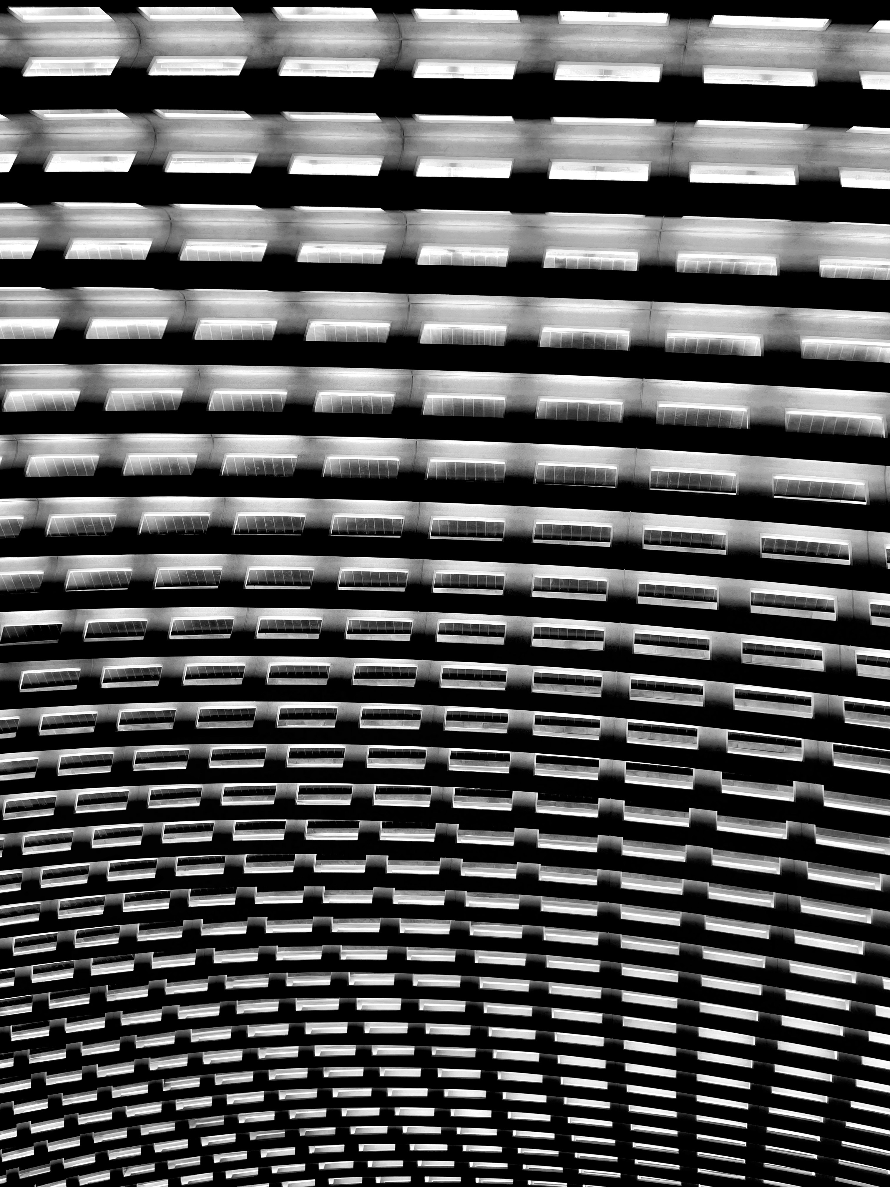 A gridded ceiling lights up the dark.