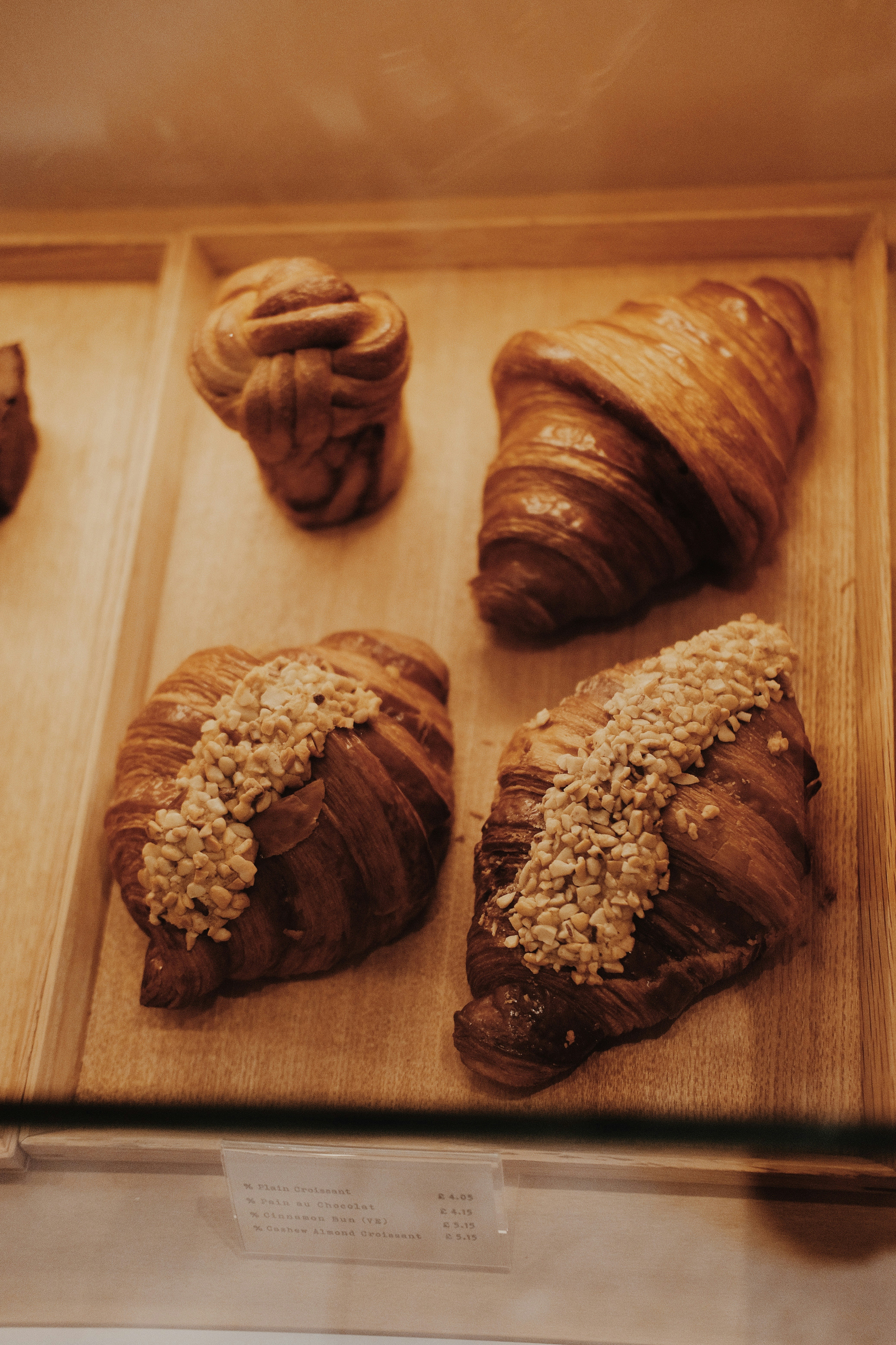 Delicious croissants are displayed in a bakery.