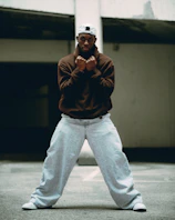 A man poses aggressively with clenched fists.