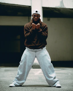 A man poses aggressively with clenched fists.
