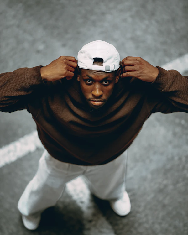 Cap & crew: Clean tee, white cap, easy smile