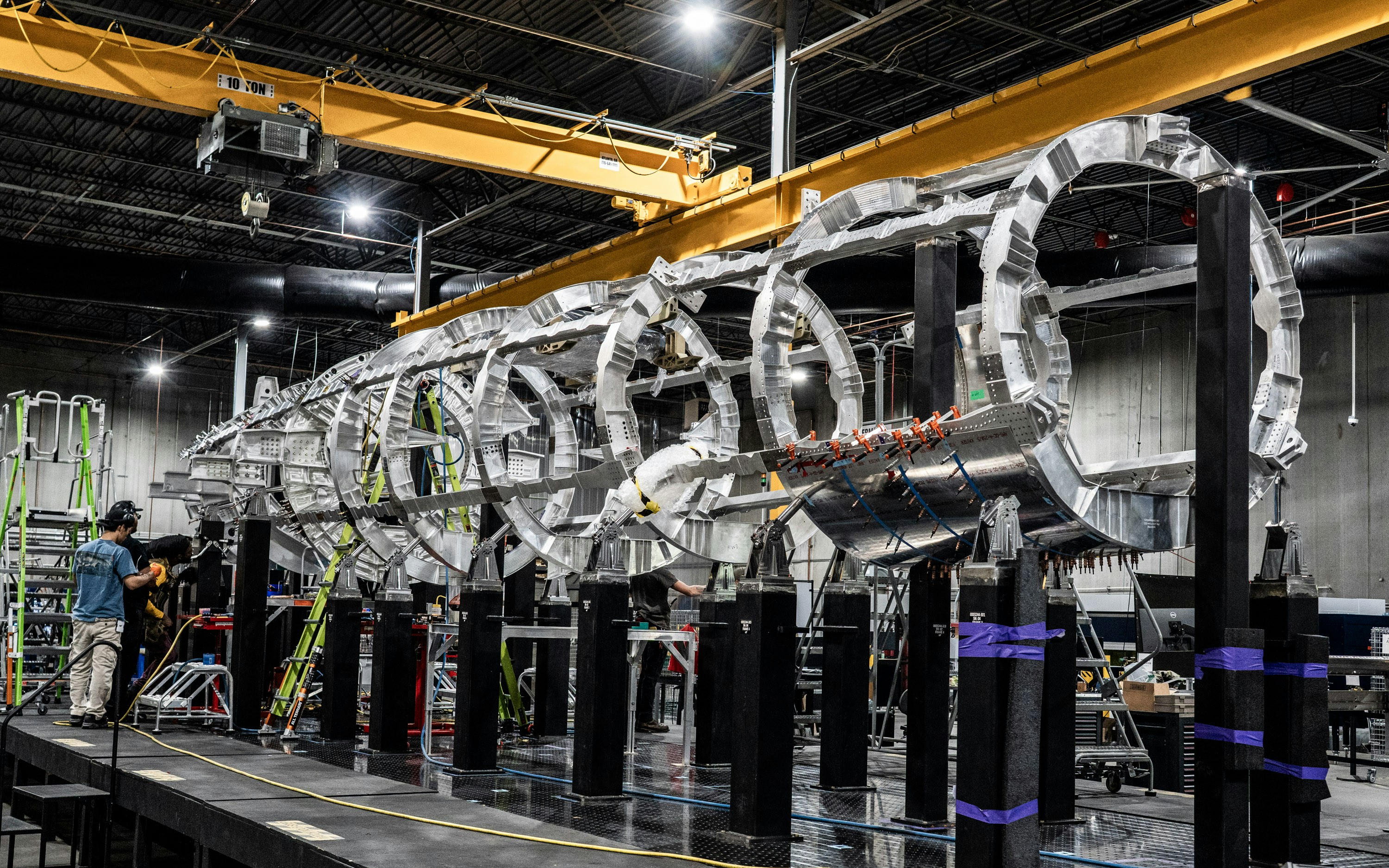 A large aircraft fuselage under construction.