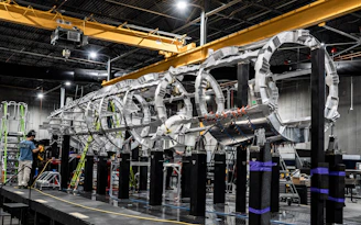 A large aircraft fuselage under construction.