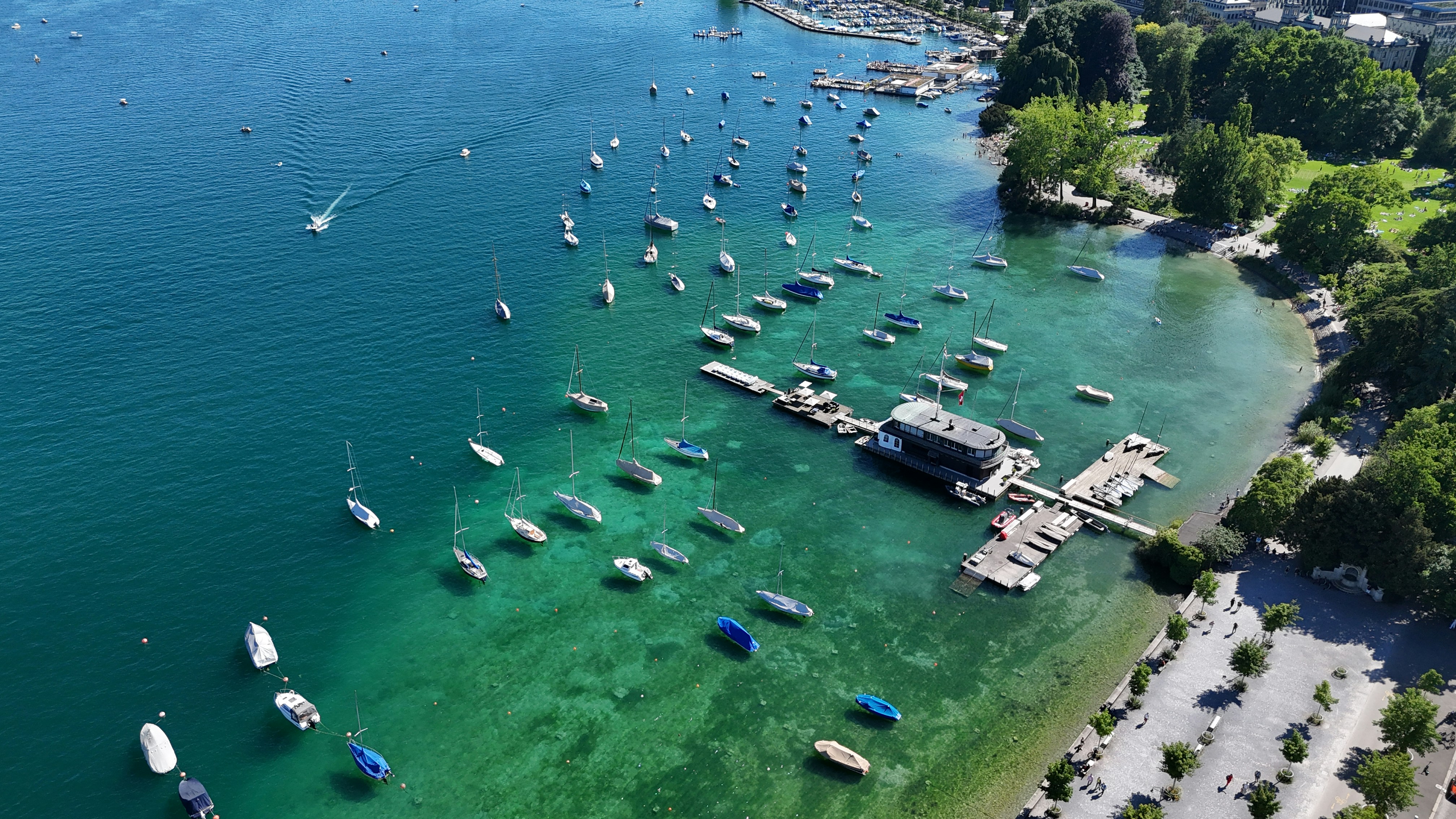 Boats dot a beautiful bay with crystal-clear water.
