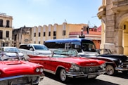 Classic cars parked on a vibrant city street.
