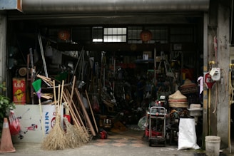 A cluttered shopfront displays various tools and equipment.