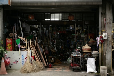 A cluttered shopfront displays various tools and equipment.