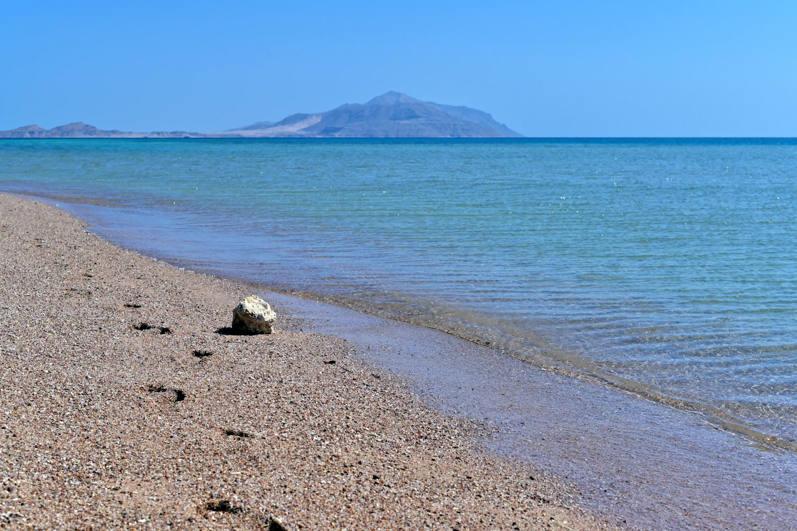 The Red Sea shore at Sharm el-Sheikh, with Tiran island on the horizon