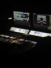 A lighting console controls lights for a performance.