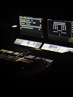 A lighting console controls lights for a performance.