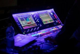 Someone is operating a sound mixing console.