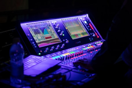 Someone is operating a sound mixing console.