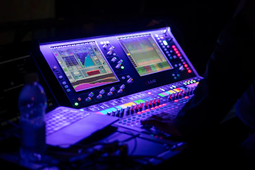 Someone is operating a sound mixing console.