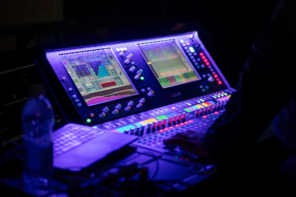 Someone is operating a sound mixing console.