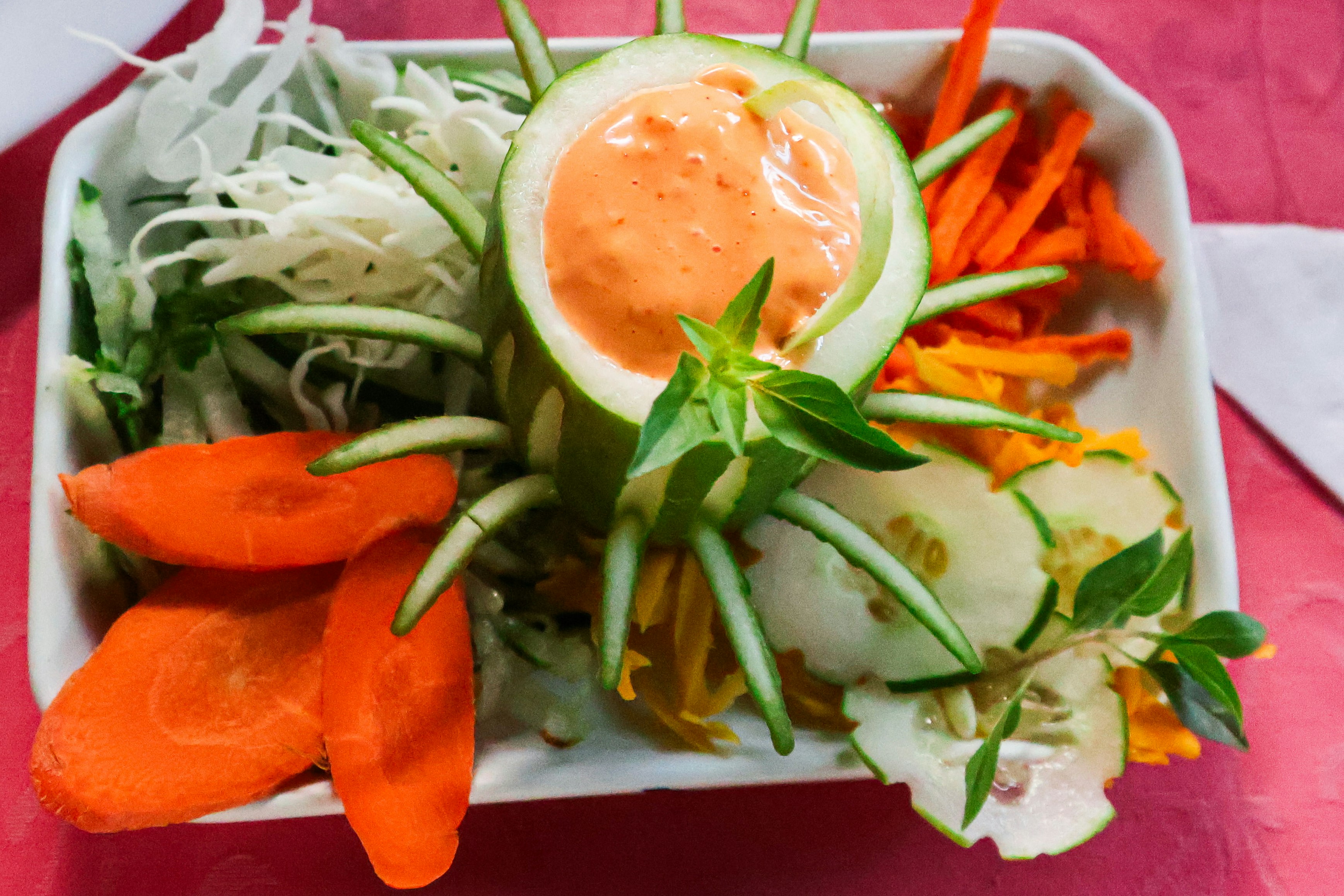 A colorful salad with a creamy dressing.