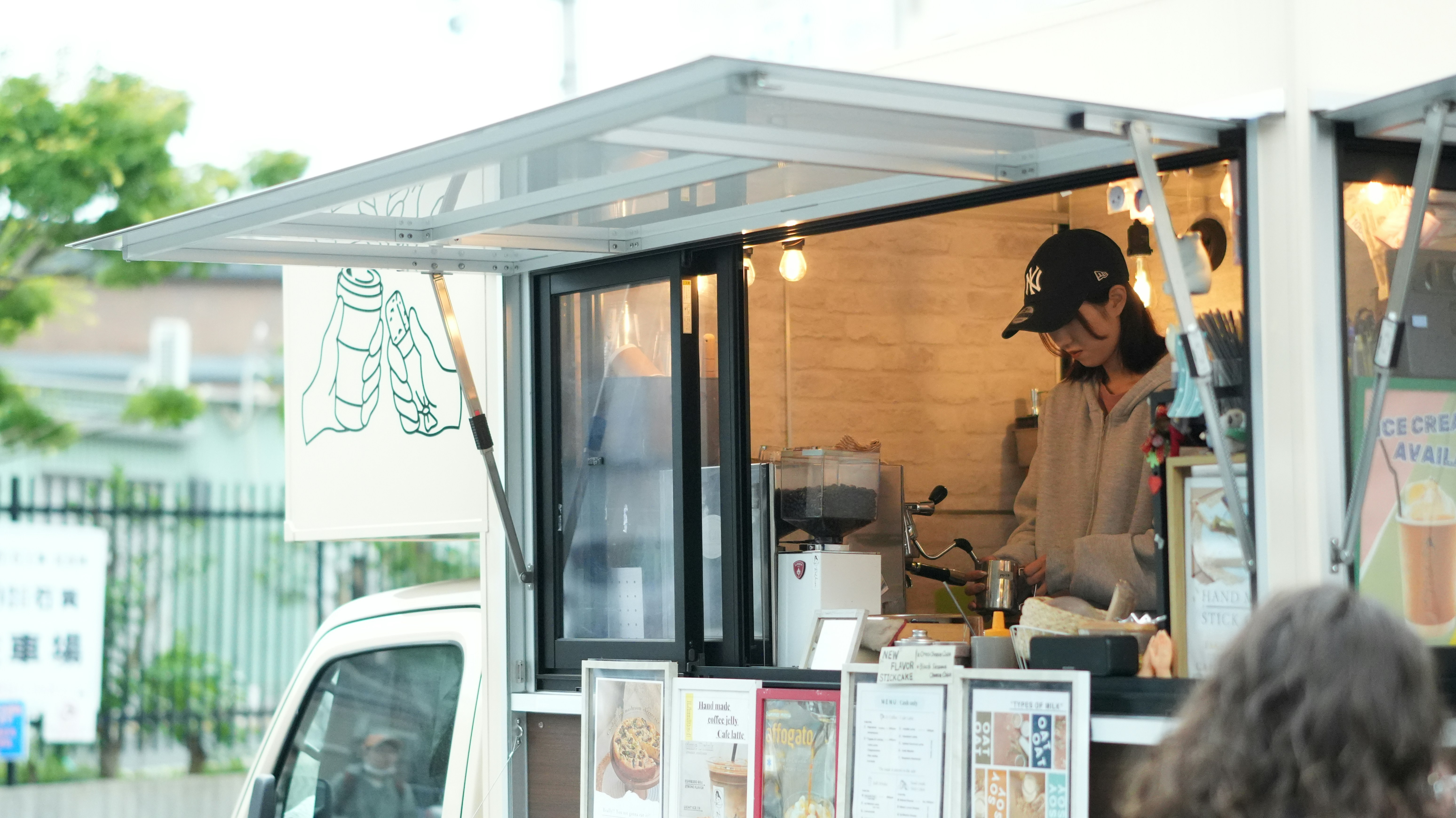 Woman working inside a food truck.