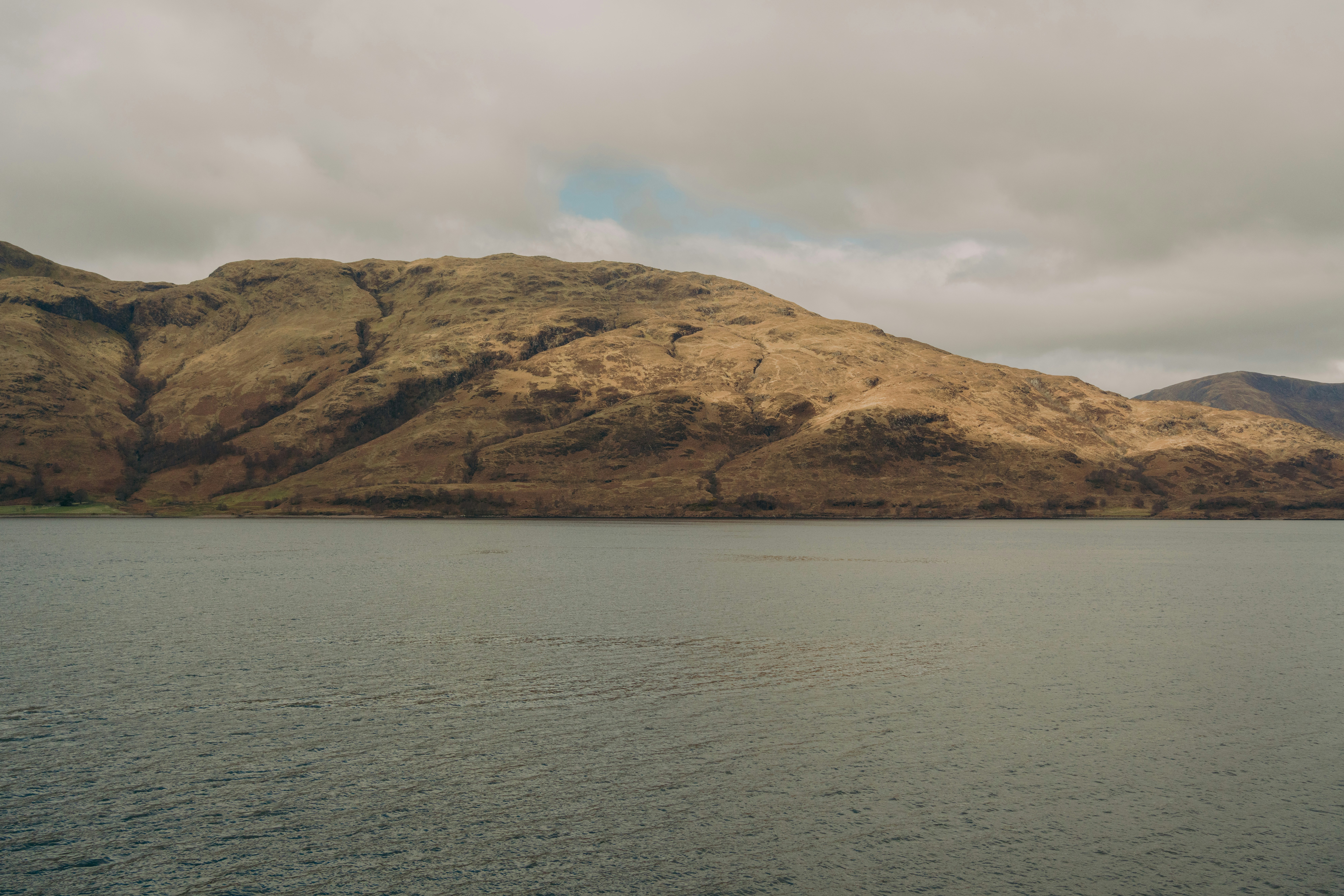 Mountainous landscape overlooks the calm water.