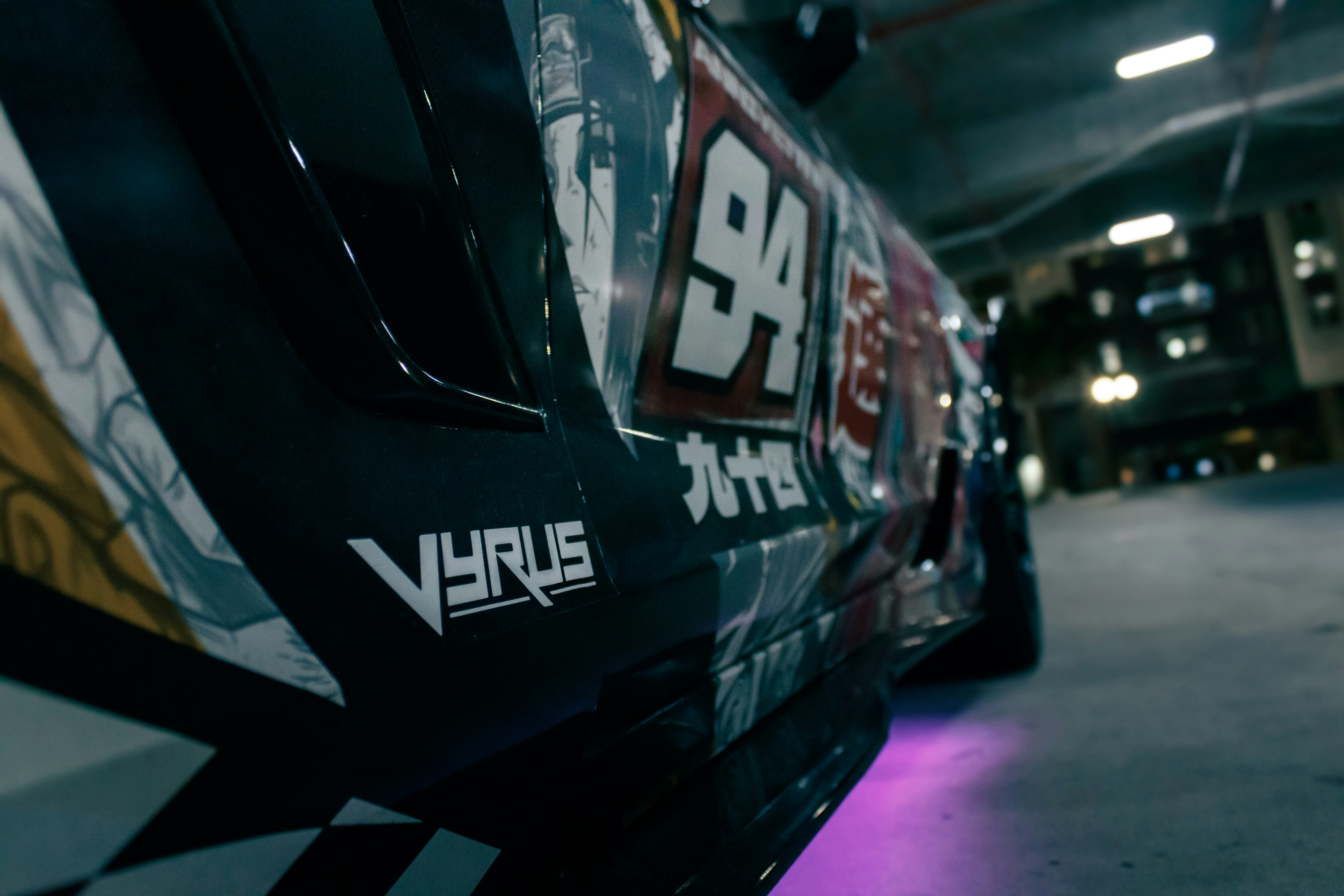 A racing car's side shows the brand vyrus.
