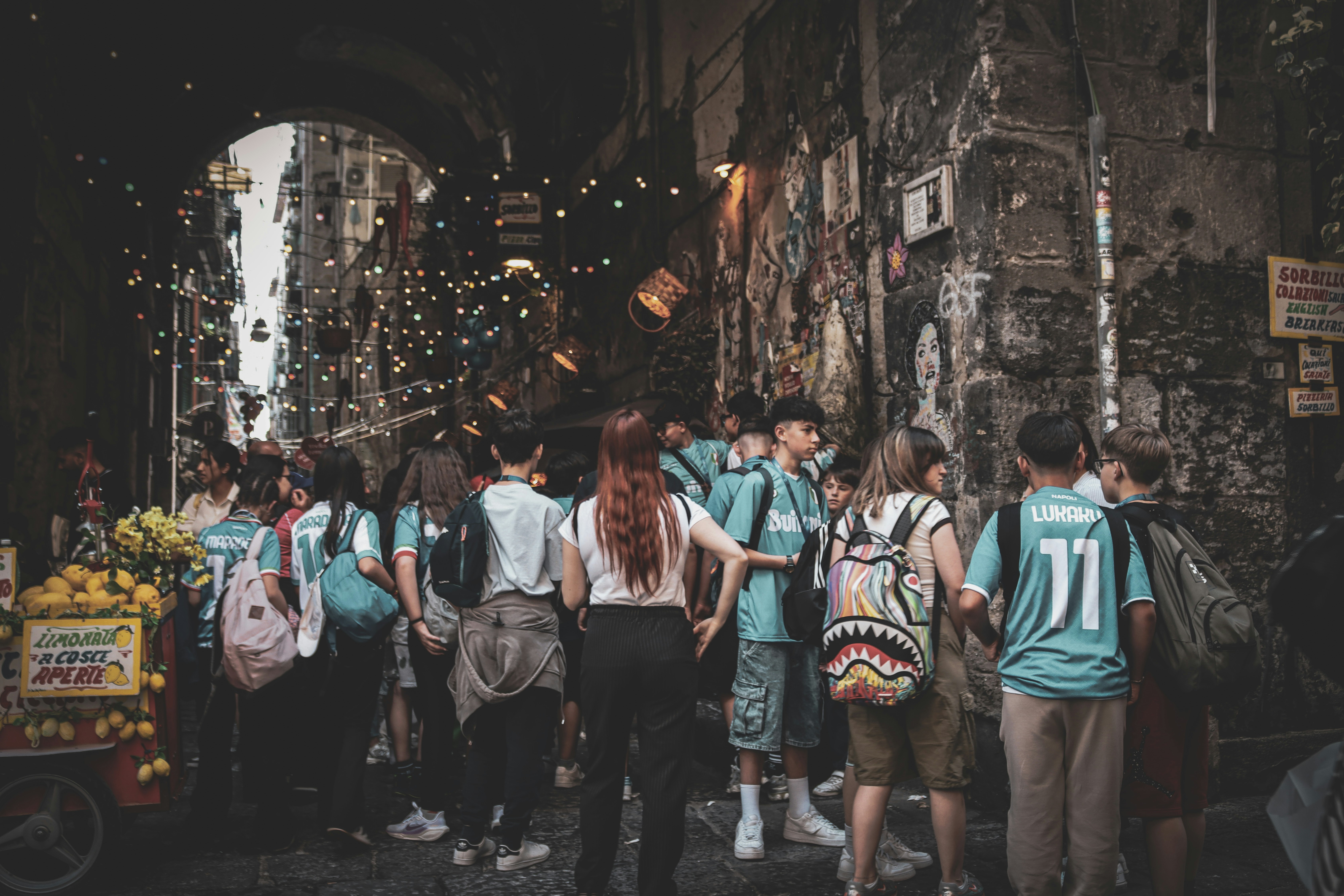 People are walking through a city archway.