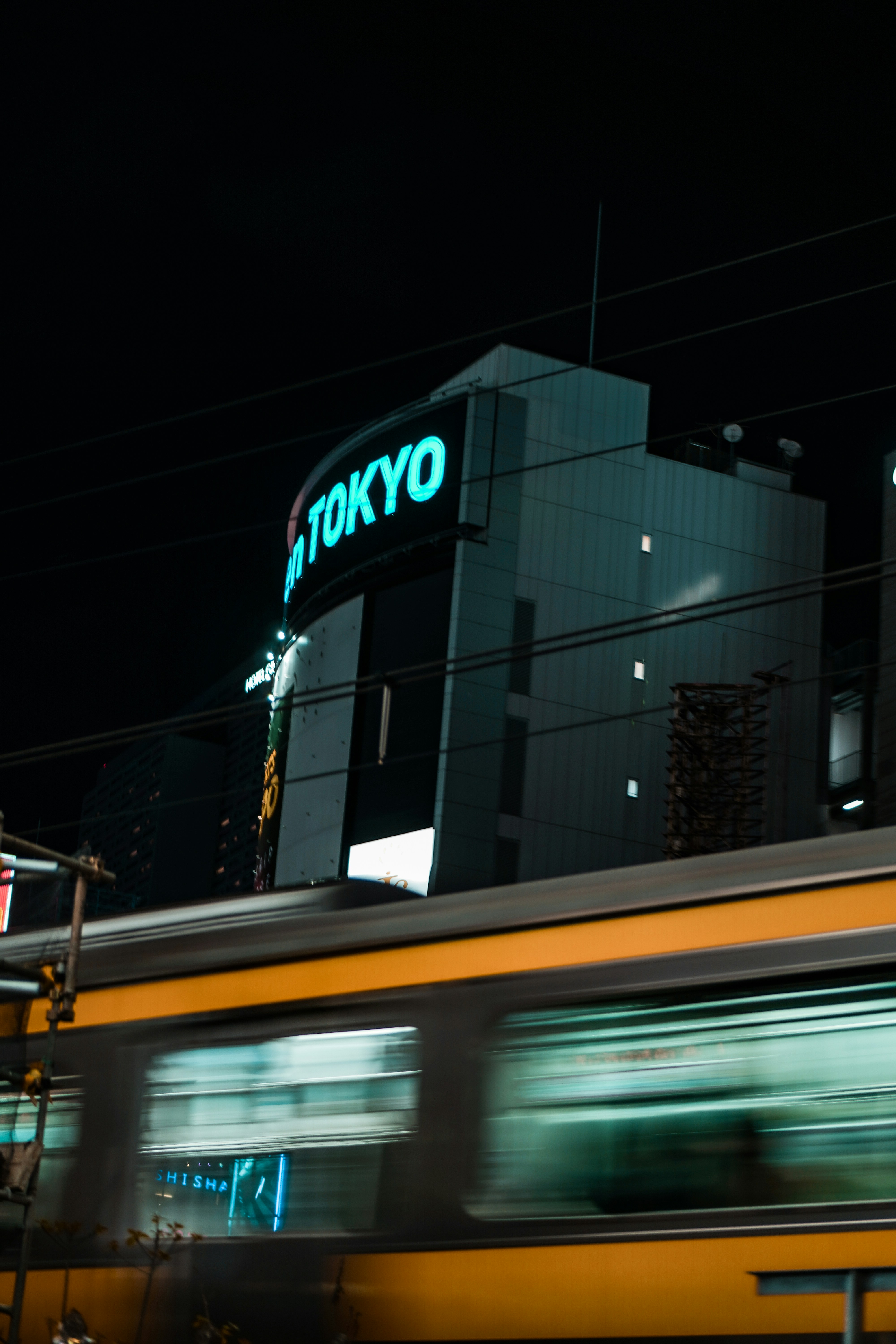 Tokyo skyline at night with a train.