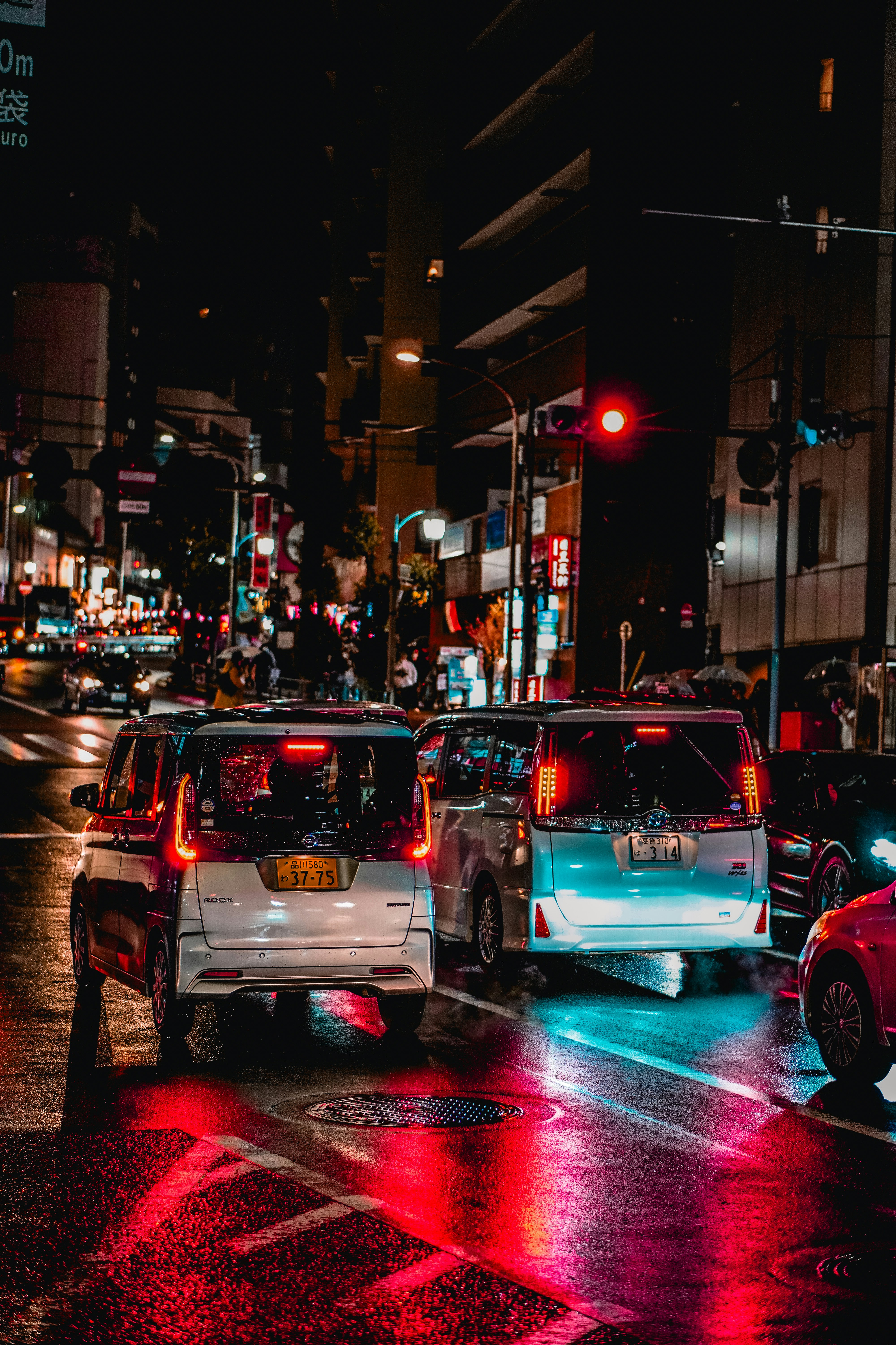 Cars are stopped at a red light in the city.