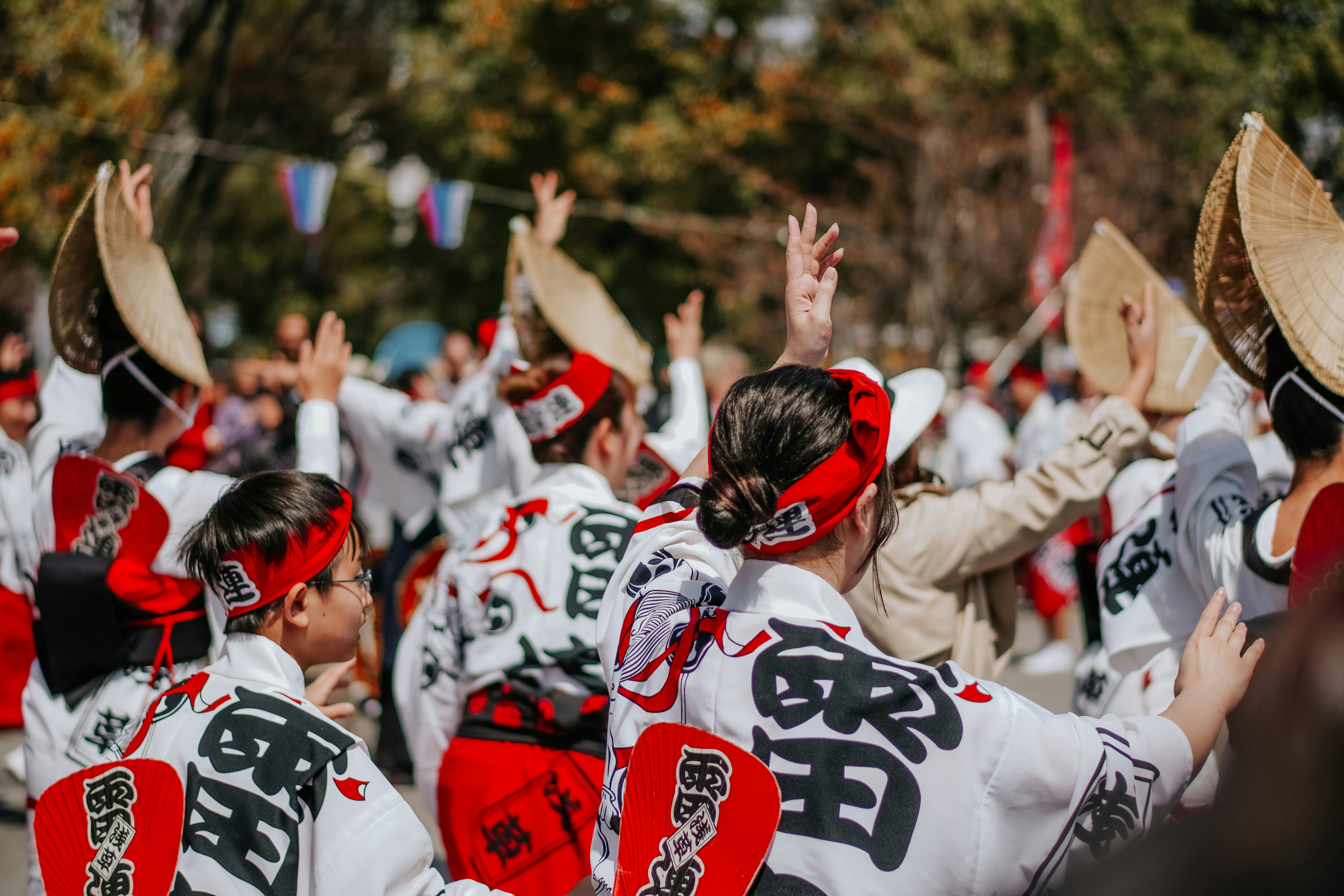 People dance in a japanese festival parade.